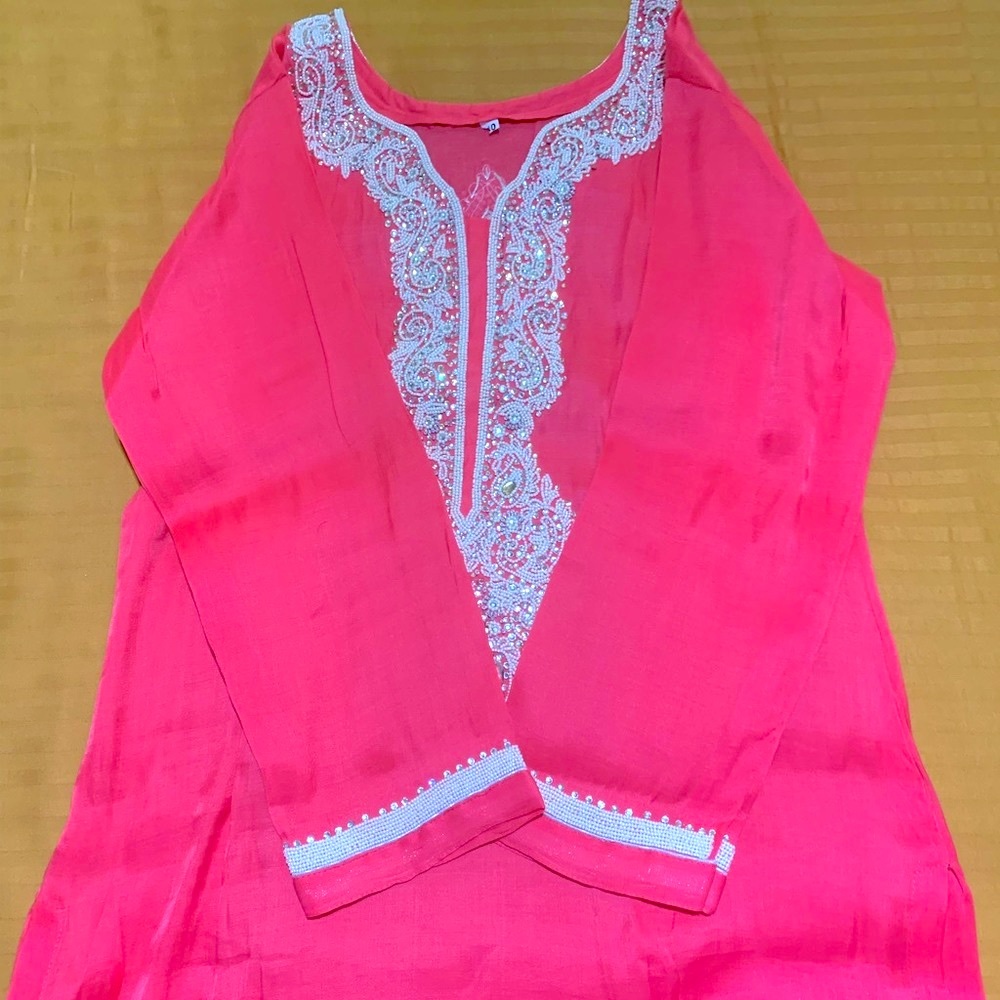 Bright pink top with stone and mirror work